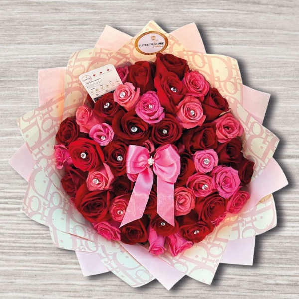 Bouquet of red and pink roses with a pink ribbon bow