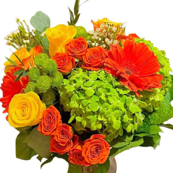 Bouquet of orange and yellow roses with a bright green hydrangea in a vase.