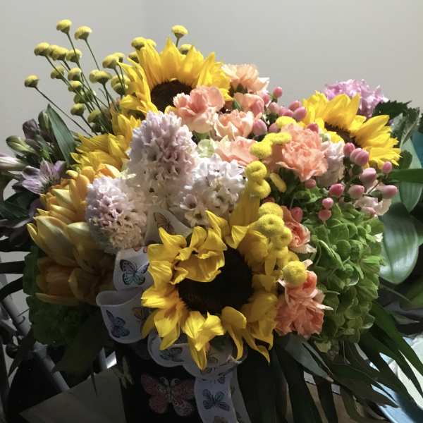 Bouquet with sunflowers, pastel carnations, and hyacinths