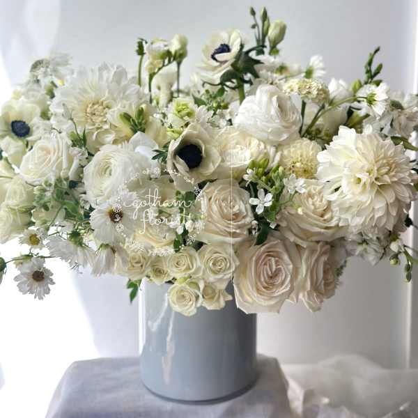 White floral arrangement in a blue vase