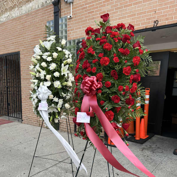 Two standing floral sprays with red and white flowers on easels