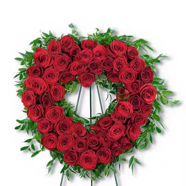 Heart-shaped wreath of red roses on a standing easel