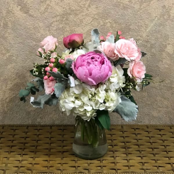 Pink and white flower arrangement in a glass vase