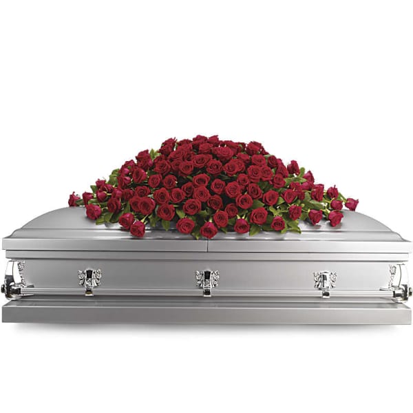 Red rose casket spray on a silver casket
