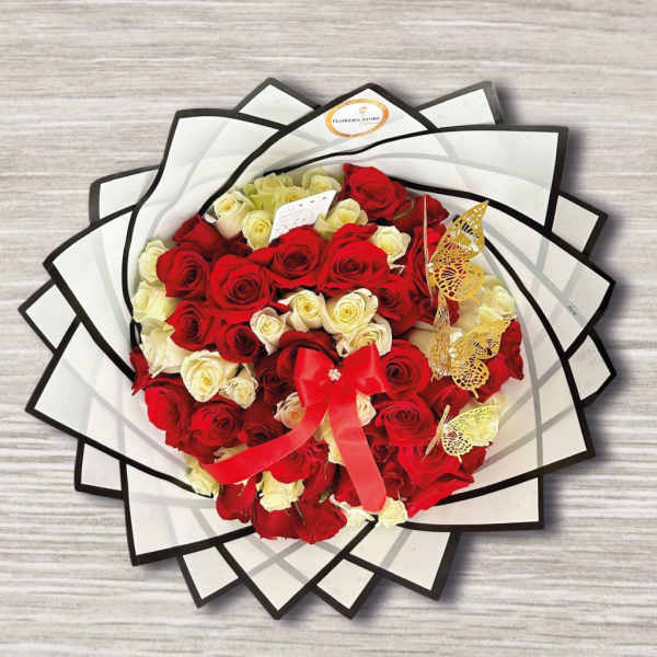 Bouquet of red and white roses wrapped in black-edged paper