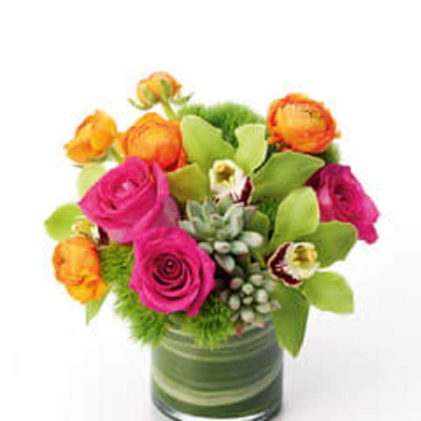 Pink and orange flowers arranged in a glass vase