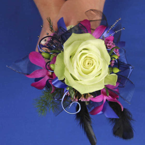 Corsage with a pale green rose and pink accents on a wrist