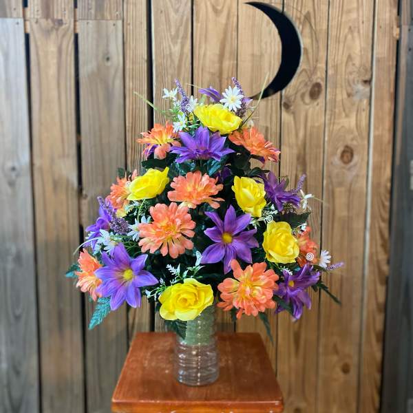 Colorful artificial flower arrangement in a clear vase