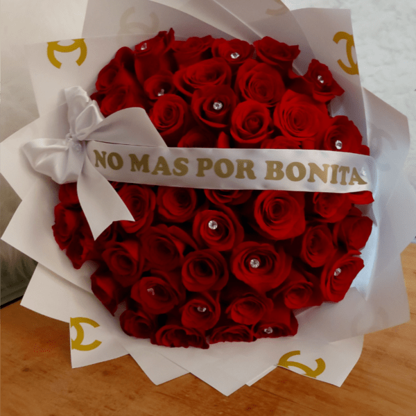 A bouquet red roses. Wrapped in designer paper