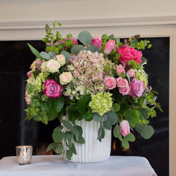Pink and white floral arrangement in a white vase