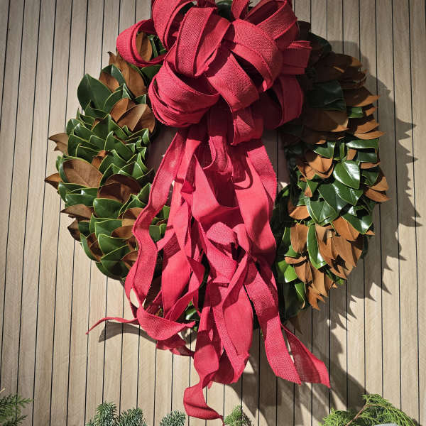 Decorative wreath with a large red ribbon bow