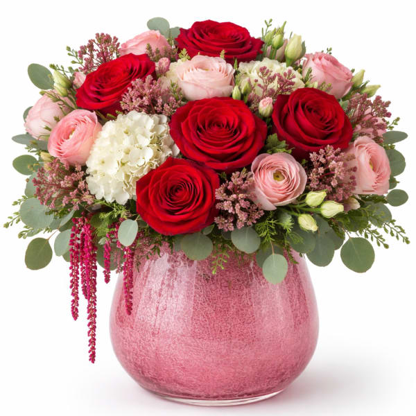 Pink and red rose bouquet in a pink glass vase