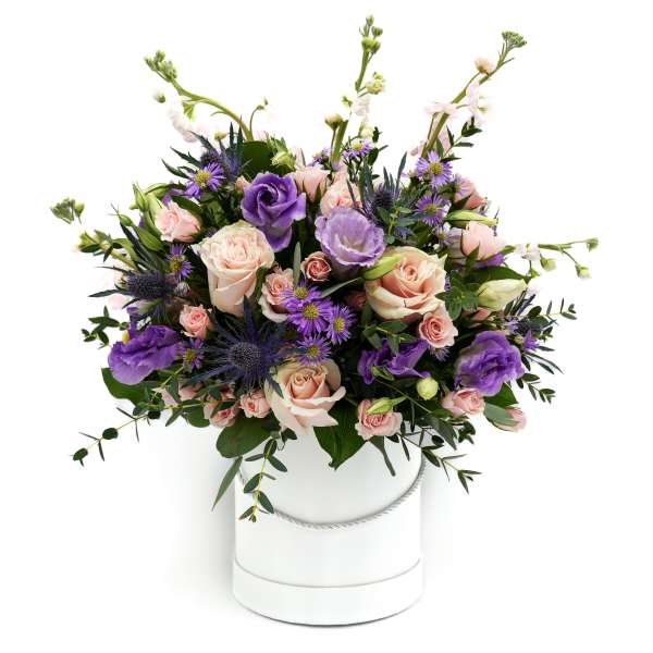 Pink and purple bouquet in a white hatbox