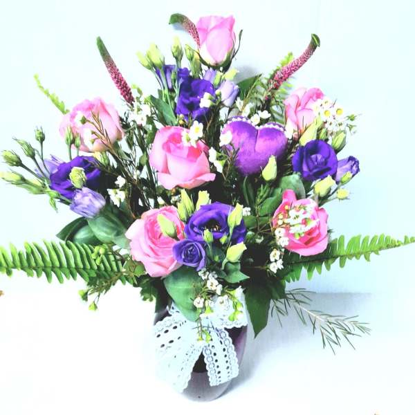 Pink and purple mixed bouquet in a vase with lace ribbon