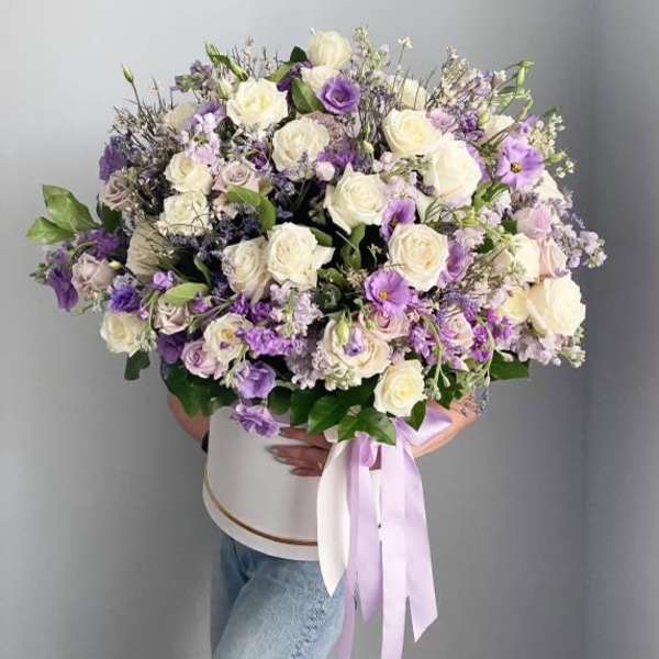 Large bouquet of white and lavender roses with a ribboned box
