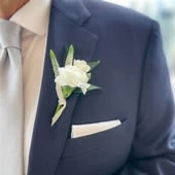 White boutonniere on a navy suit jacket