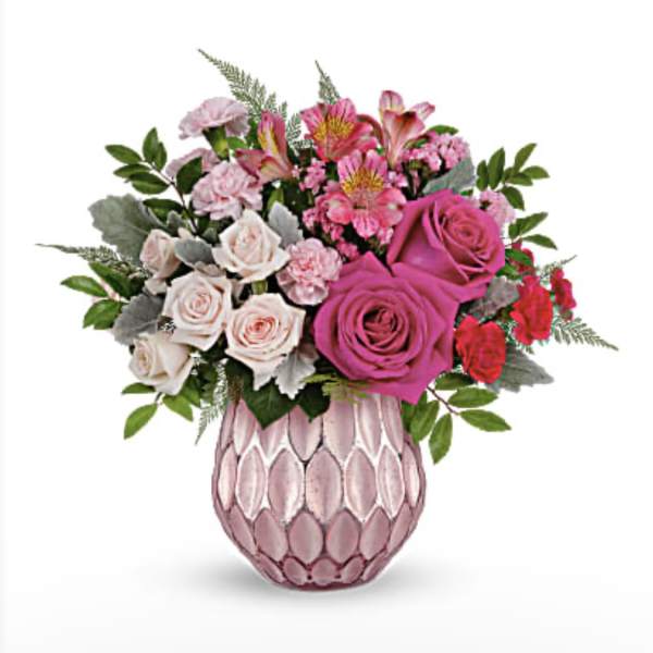 Bouquet of pink and white roses in a pink textured vase