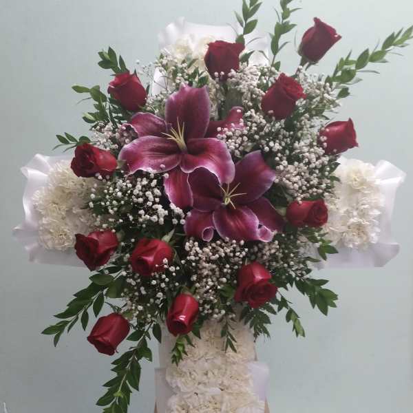 Tall floral standing spray with red roses, purple lilies, and white flowers