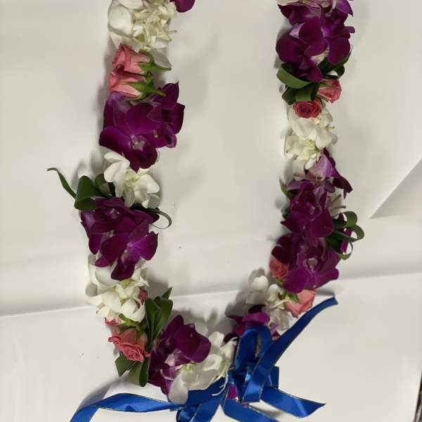 Flower lei with purple orchids, white blooms, pink roses, and a blue ribbon