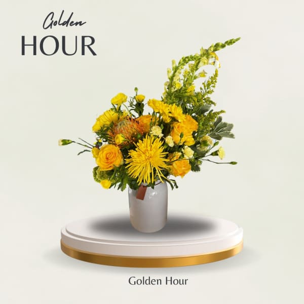 Yellow floral arrangement in a white vase