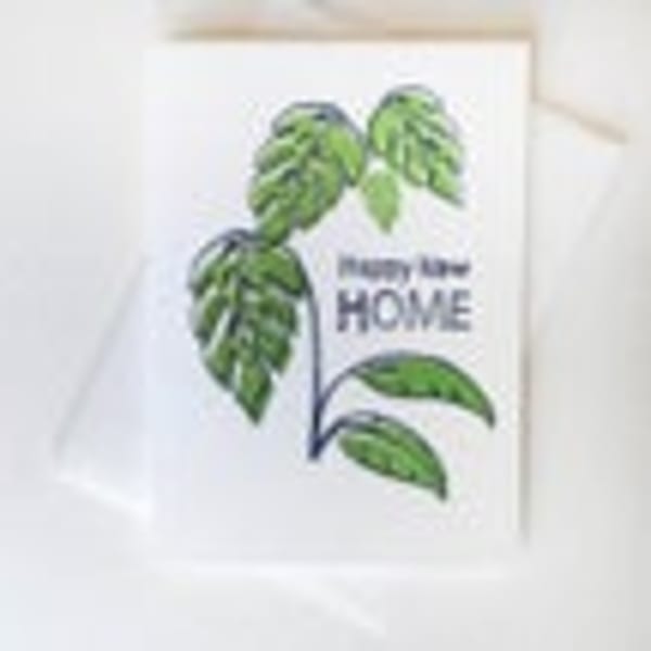 White card with green leaf illustration and the words "Happy Life Home"