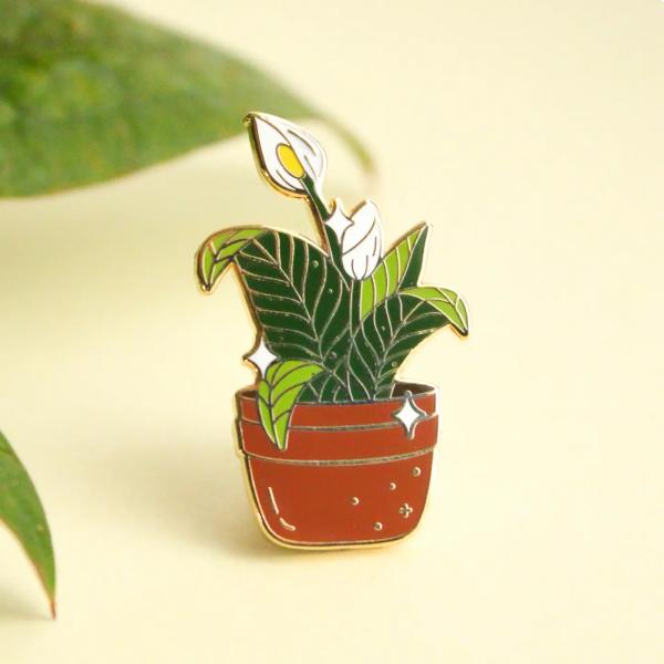Enamel pin of a potted calla lily plant