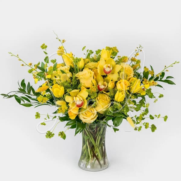 Yellow floral arrangement in a clear glass vase