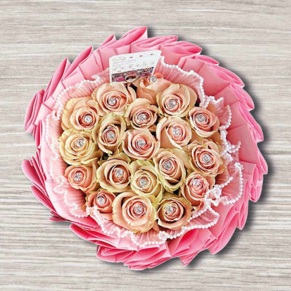 Pink and peach rose bouquet with decorative wrapping and pearl trim
