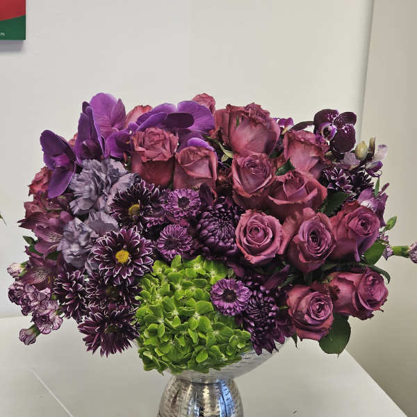 Purple and pink mixed bouquet in a silver vase