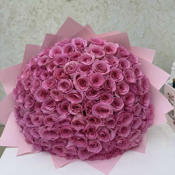 Large bouquet of pink roses wrapped in pink paper