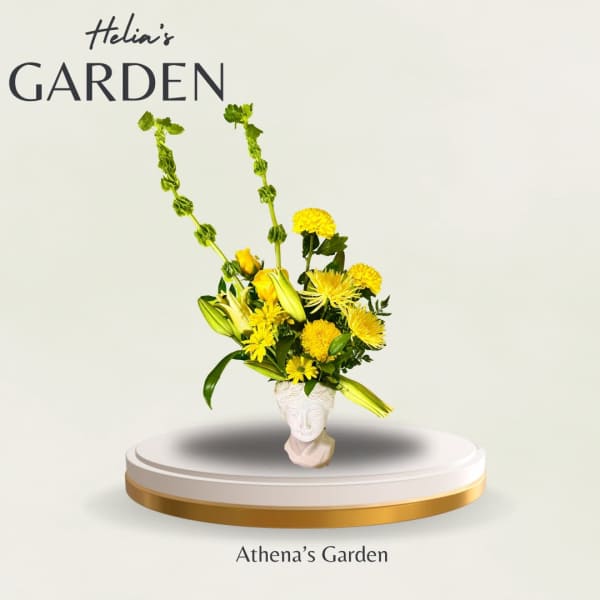 Yellow floral arrangement in a white face-shaped vase