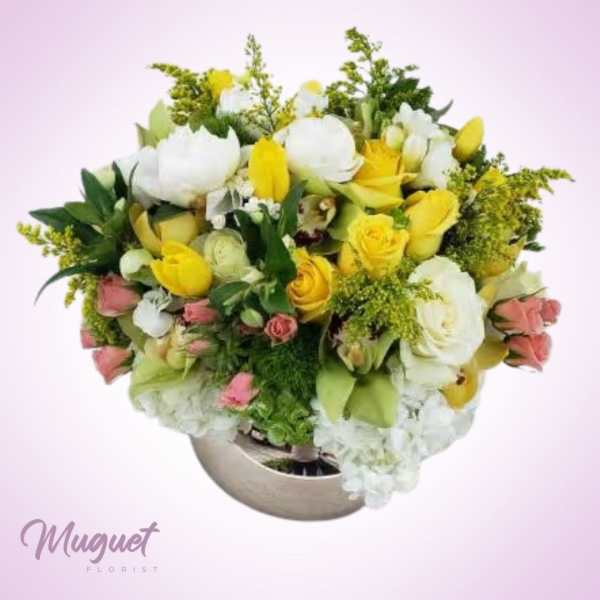 Mixed bouquet of white and yellow flowers in a round vase