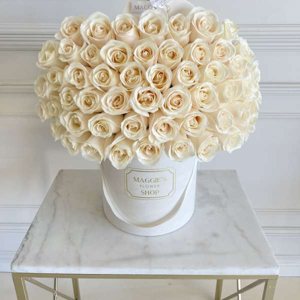 Bouquet of cream roses in a white hatbox