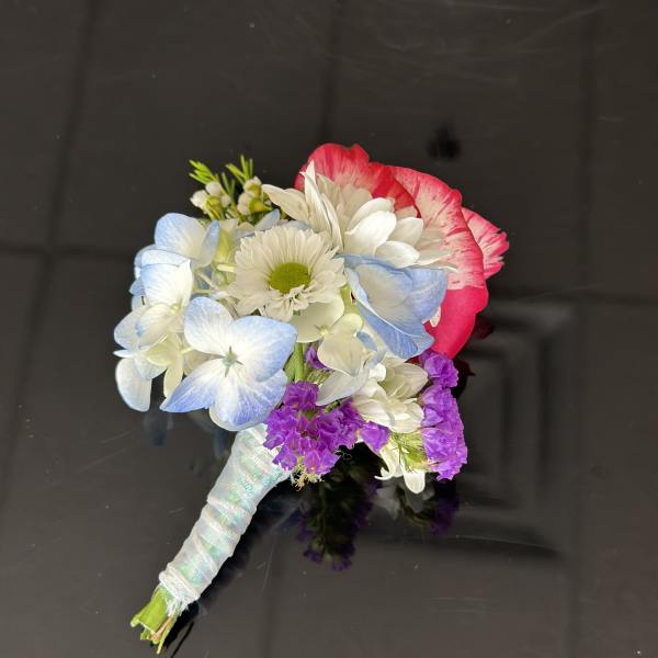 Small hand-tied bouquet with blue hydrangea, white daisies, and pink-edged blooms
