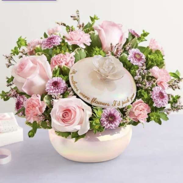 Pink roses and small pink flowers arranged in a round hatbox