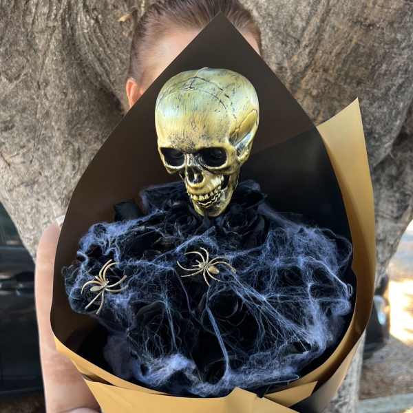 Halloween bouquet with a skull topper and black spiderweb accents