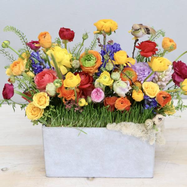 Colorful mixed bouquet in a rectangular gray container