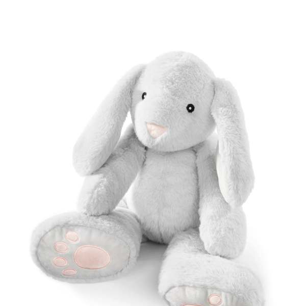 White plush bunny with pink paw pads sitting on a white background