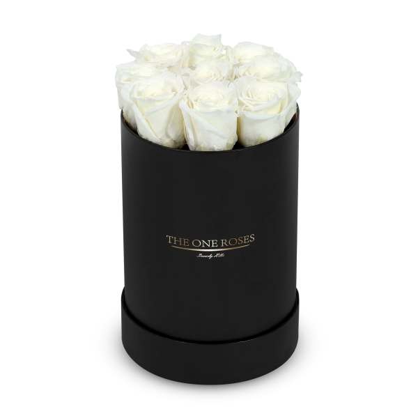 White roses in a black cylindrical box