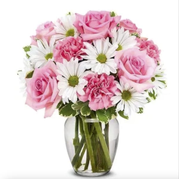 Pink roses and white daisies in a clear glass vase