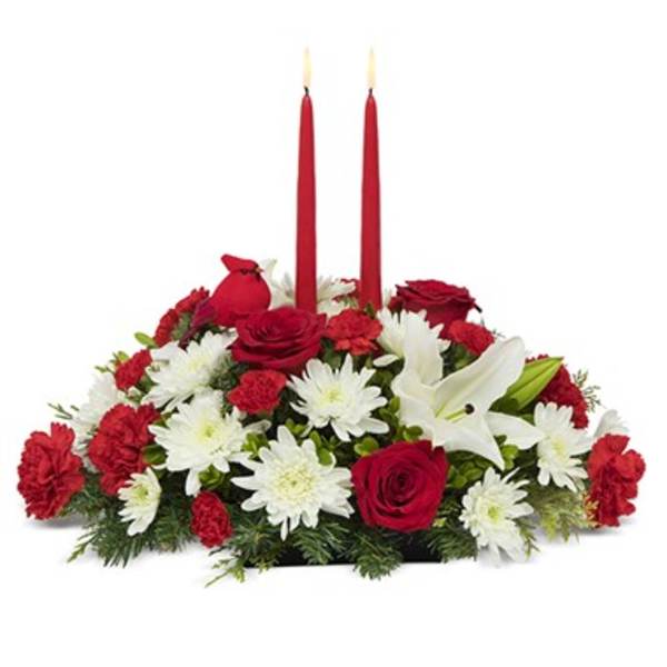 Red and white floral centerpiece with two tall red candles