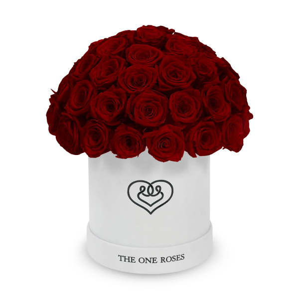 Red roses arranged in a white round box with a heart logo