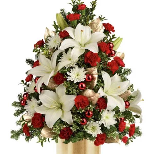 Christmas bouquet with white lilies, red carnations, and white daisies in a gold vase