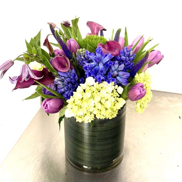 Colorful bouquet in a black cylindrical vase