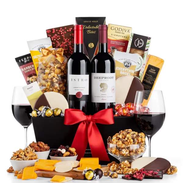 Gift basket with wine, chocolates, cheese, and snacks tied with a red ribbon