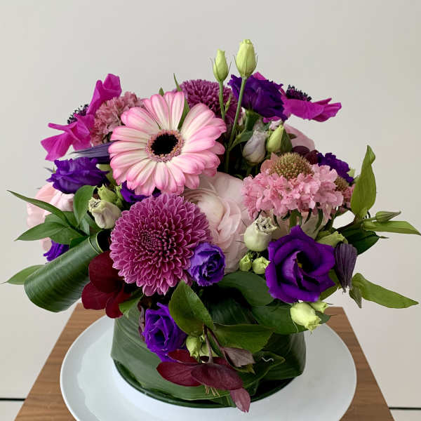 Pink and purple mixed bouquet in a glass vase