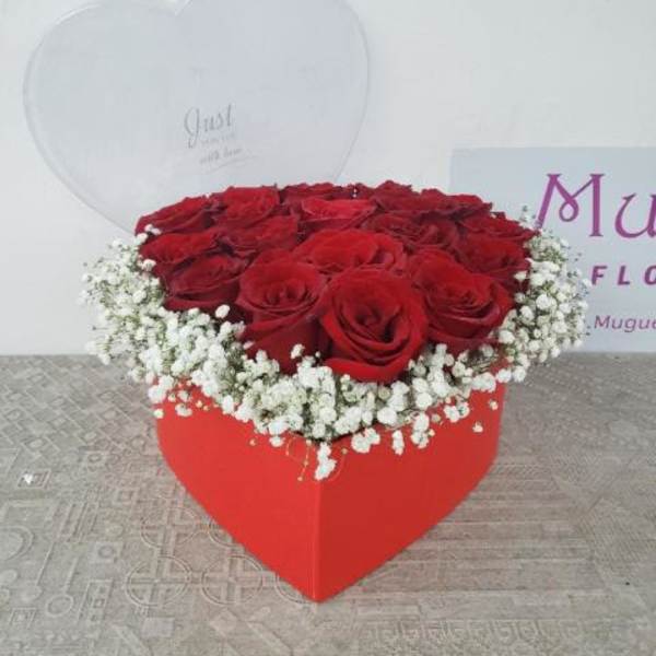 Heart-shaped box of red roses with white baby's breath
