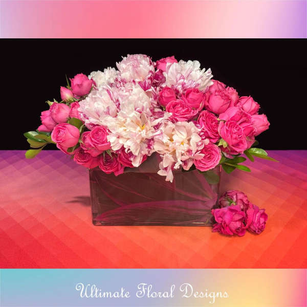 Pink and white bouquet in a rectangular glass vase
