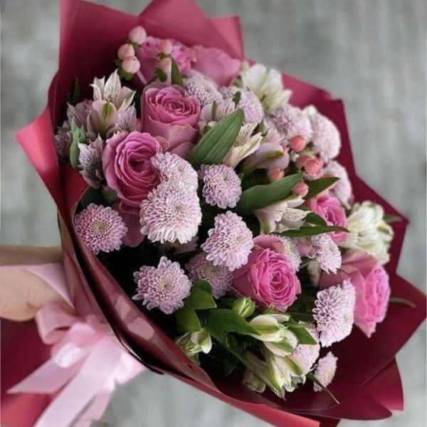 Pink rose and chrysanthemum bouquet wrapped in magenta paper