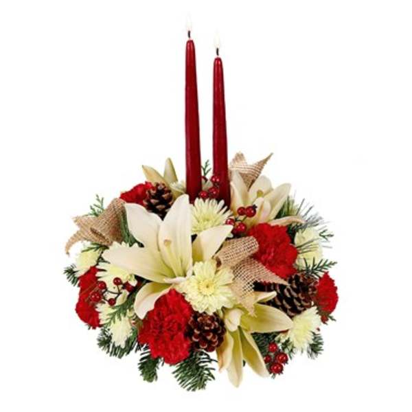 Holiday floral centerpiece with red candles and cream flowers